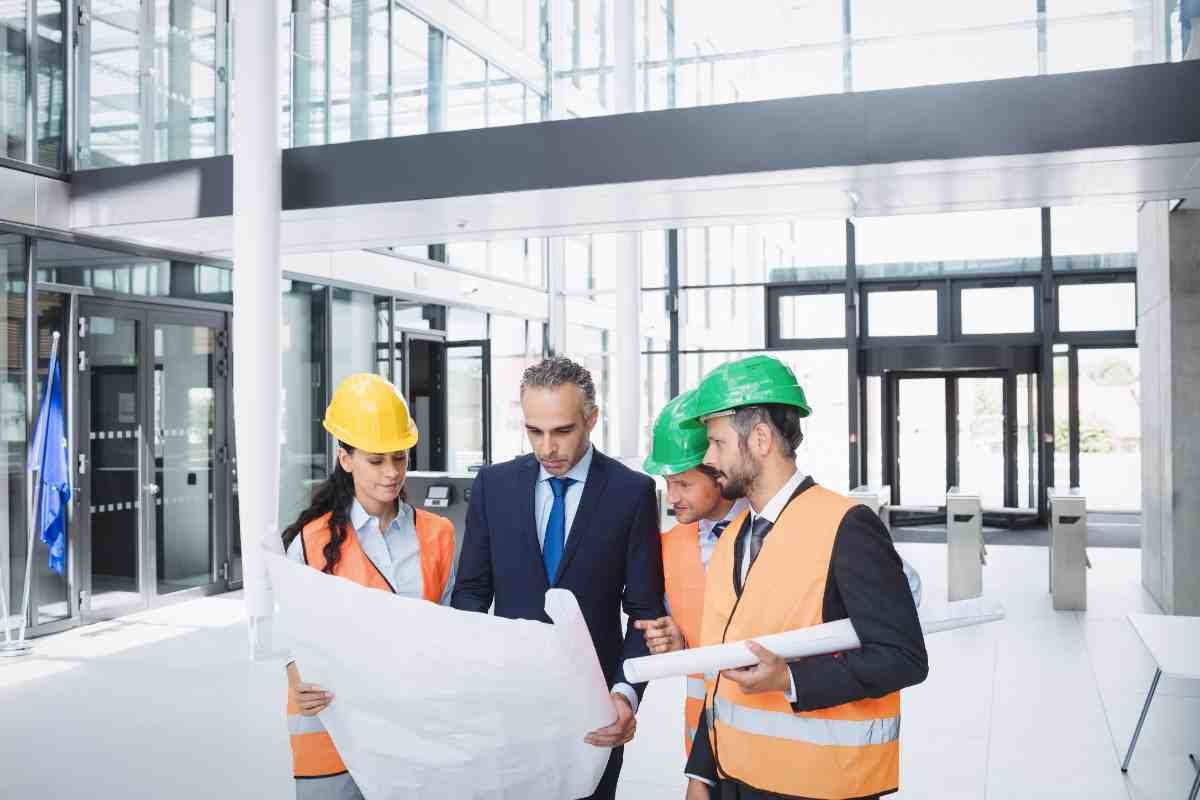 businessman-discussing-blueprint-with-architects-50kb