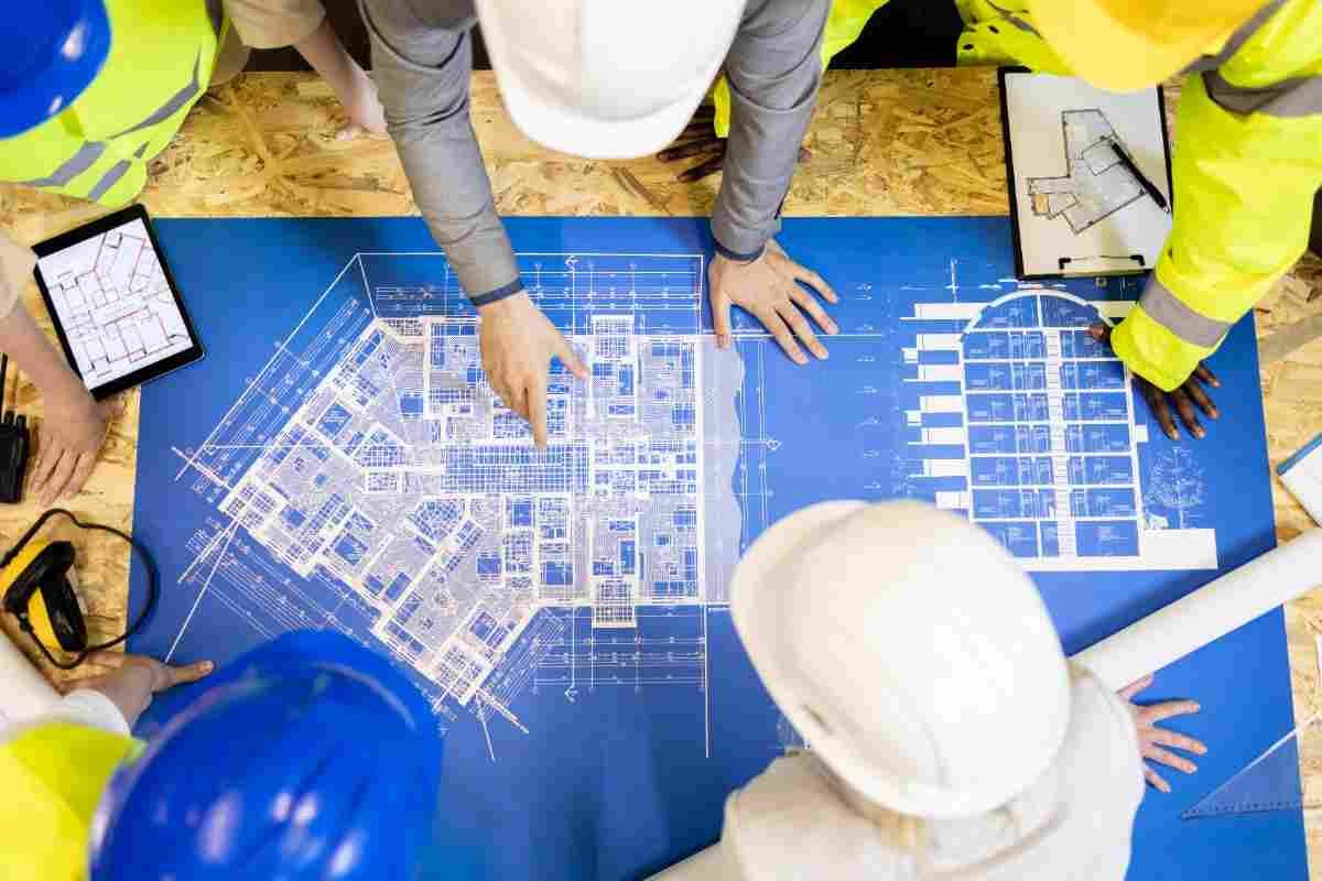 top-view-architects-engineers-analyzing-blueprint-project-plant-50kb